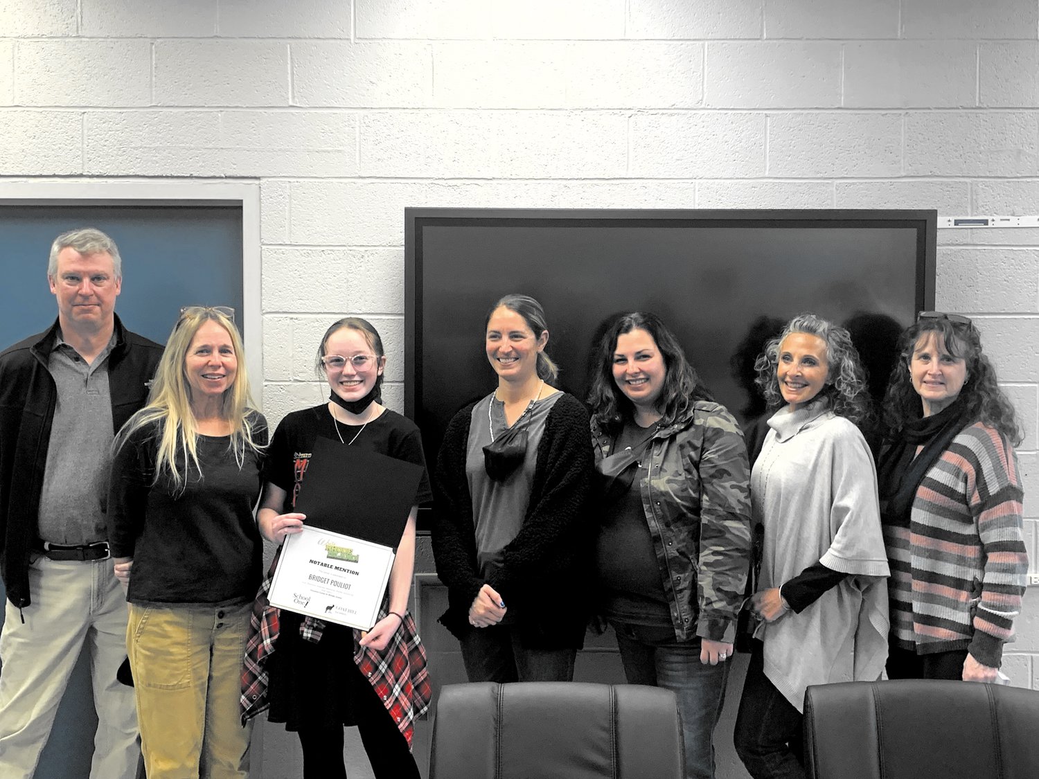 YOUNG AUTHOR: Warwick Vets eighth grader Bridget Pouliot recently received  a notable mention in the Write Rhode Island short fiction competition. Pictured left to right: Peter Stone, Brenda Asplund, Bridget Pouliot, Meredith McSwiggan, Kate Uva, Patricia Bastia, and Pat Burton. (Warwick Beacon photo)